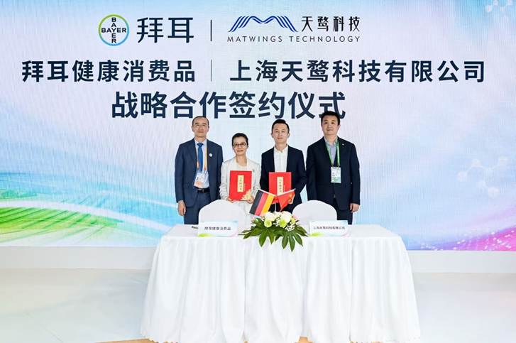 A group of people standing in front of a table with white tableclothsAI-generated content may be incorrect.