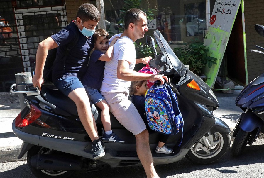 Mideast in Pictures More Lebanese families resort to motorbikes for