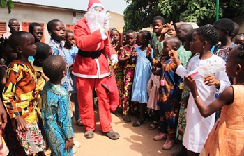 Man dressed as Santa Claus visits children in private school in Benin