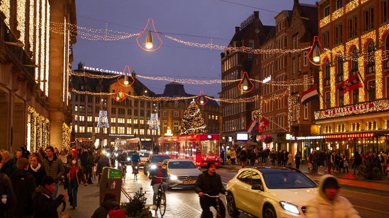 People walk on street with Christmas decorations in Amsterdam