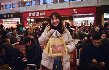 Passengers bring gifts for families as they head home for Spring Festival