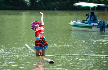 People perform single bamboo drifting on water in Chishui, SW China