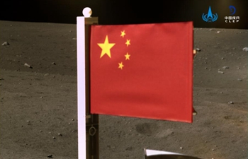 China's space agency releases images of national flag unfurled on moon